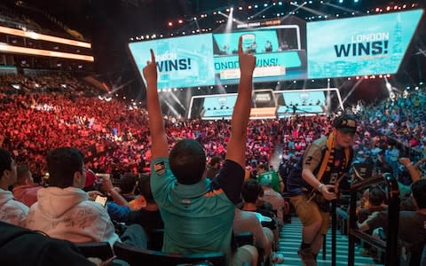 In this July 28, 2018, file photo, London Spitfire fan Rick Ybarra, of Plainfield, Ind., reacts after London won the second game against the Philadelphia Fusion during the Overwatch League Grand Finals competition at Barclays Center in New York - Credit: Mary Altaffer/AP