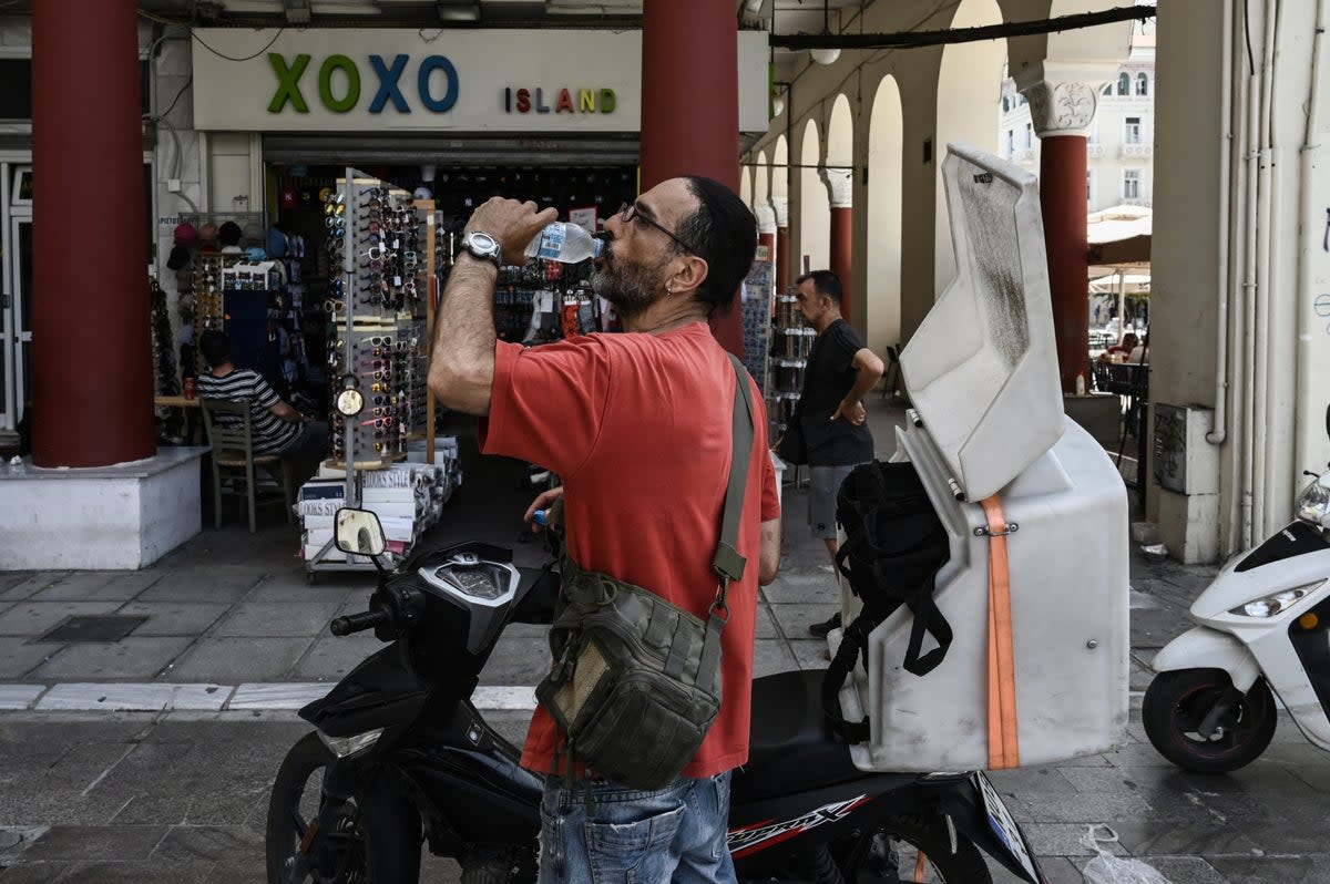 A delivery man drinks water in Thessaloniki (AFP via Getty Images)