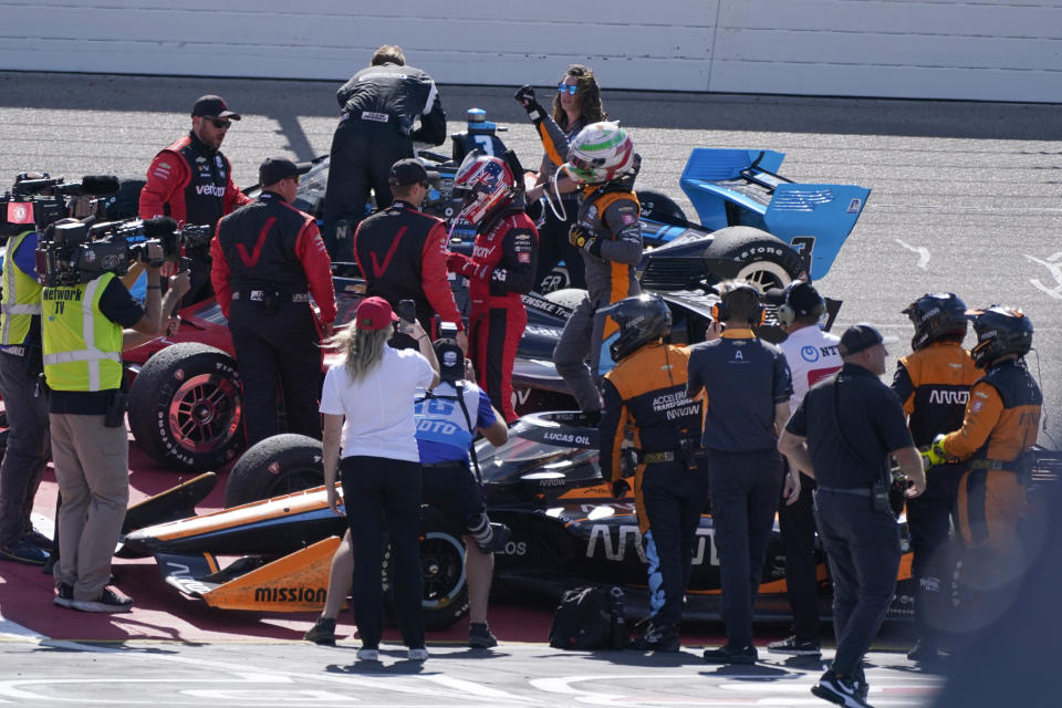 Pato O'Ward, center right, of Mexico, celebrates after winning an IndyCar Series auto race, Sunday, July 24, 2022, at Iowa Speedway in Newton, Iowa. (AP Photo/Charlie Neibergall)