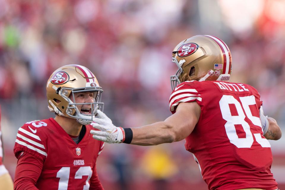 San Francisco 49ers quarterback Brock Purdy (13) and tight end George Kittle (85), one a Cyclone and the other a Hawkeye, celebrate after a touchdown.