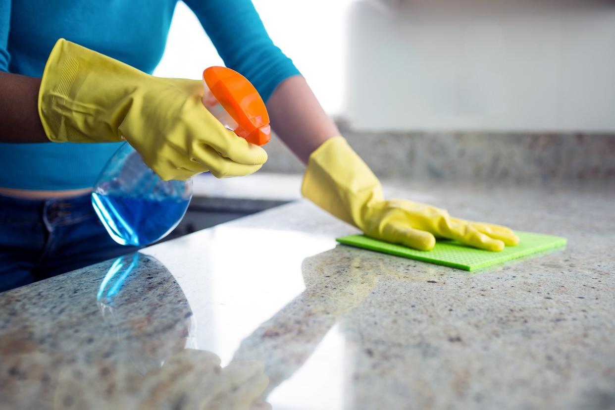 Woman scrubbing the kitchen counter