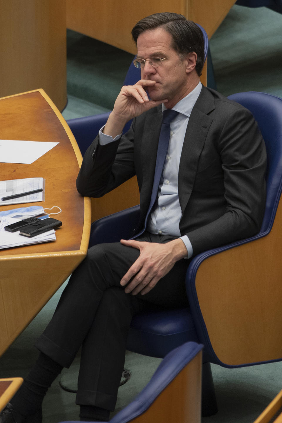 FILE - In this file photo dated Thursday, April 1, 2021, Dutch caretaker Prime Minister Mark Rutte listens to a debate in parliament in The Hague, Netherlands. Rutte announced a significant easing in his country's months-long coronavirus lockdown Tuesday April 20, 2021, calling it a delicate balancing act as infections remain stubbornly high, and as lockdown fatigue grows.(AP Photo/Peter Dejong)