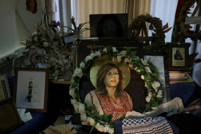 Pictures and other objects are displayed in memory of slain journalist Shireen Abu Akleh in the room that used to be her office at Al Jazeera in the West Bank city of Ramallah