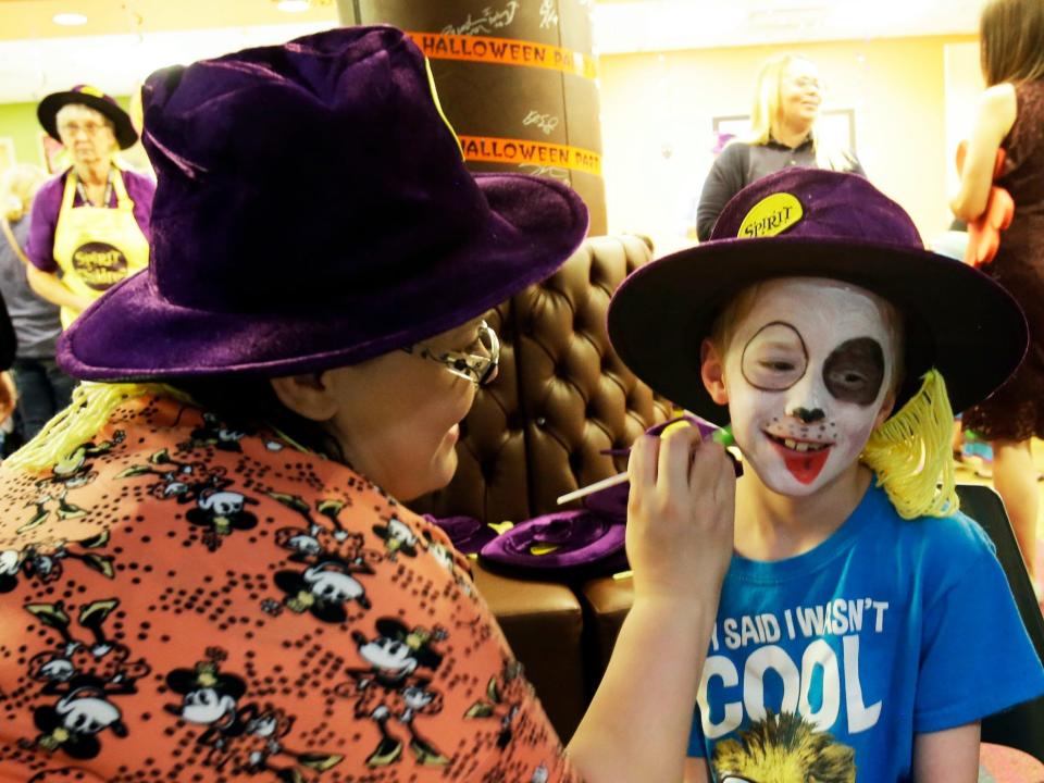 A child has her face painted at a Spirit of Children event.