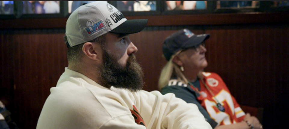 Jason watches a game with his mom, Donna Kelce, sporting her famous half-and-half jersey. (Prime Video) 