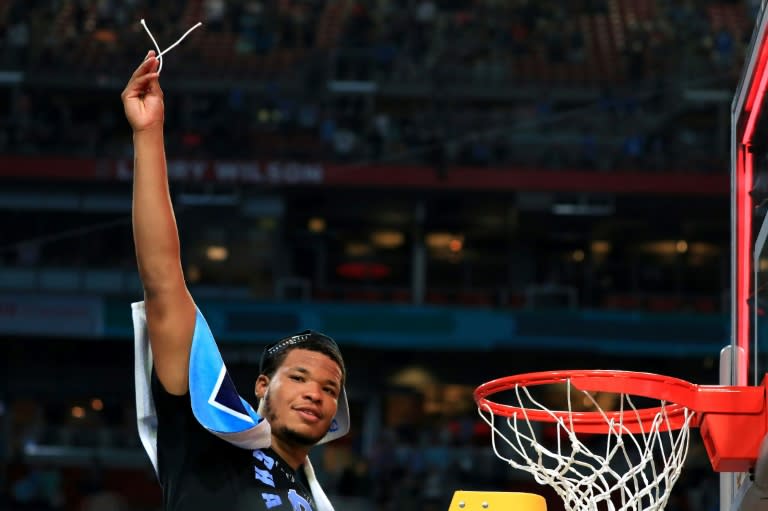 Kennedy Meeks of the North Carolina Tar Heels cuts off a piece from the net after defeating the Gonzaga Bulldogs during the 2017 NCAA Men's Final Four National Championship game, at University of Phoenix Stadium in Glendale, Arizona, on April 3