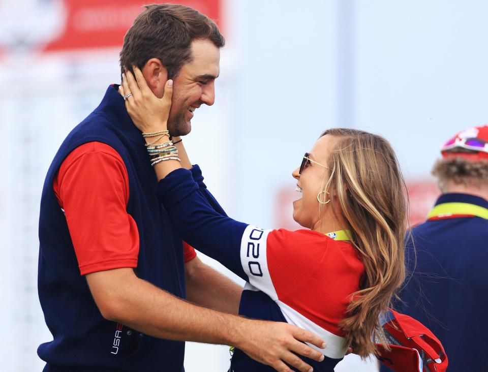 Scottie Scheffler of team United States and wife Meredith Scudder celebrate on the 15th green after defeating Jon Rahm of Spain and team Europe 4&3 during Sunday Singles Matches of the 43rd Ryder Cup at Whistling Straits on September 26, 2021 in Kohler, Wisconsin