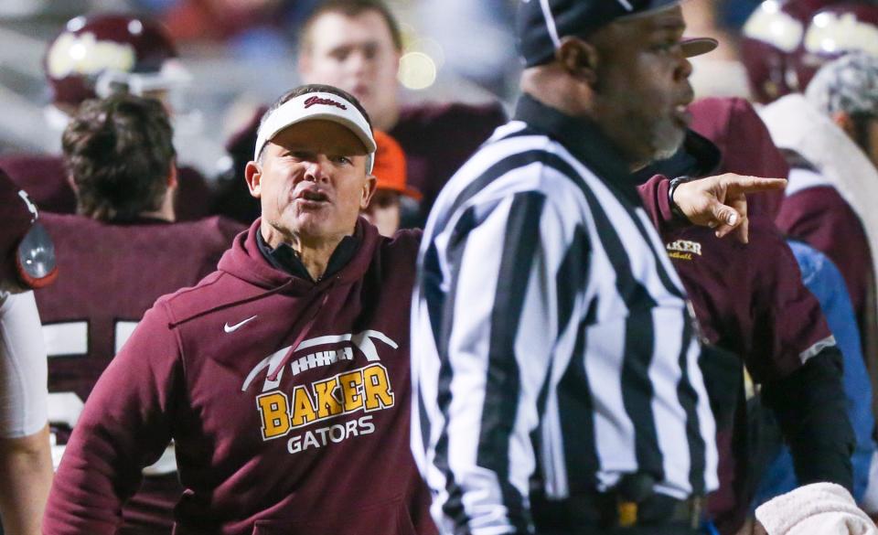 Gators head coach Matt Brunson points out what he believes was a penalty to an official during the Baker Chipley Regional Final football game played at Baker. The Gators season ended with a 22-7 loss as the Tigers advance to the state Final Four.