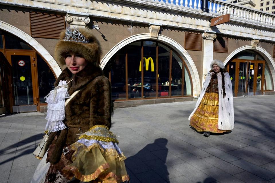 Women walk in front of a McDonald's restaurant in central Moscow on March 9, 2022. (AFP via Getty Images)