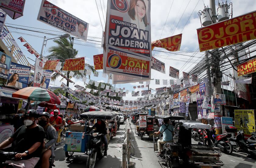 MANILA, PHILIPPINES - MAY 2022. A street in the Manila suburb of Cainta is covered in campaign posters and banners during the recent Philippine elections. (Luis Sinco / Los Angeles Times)