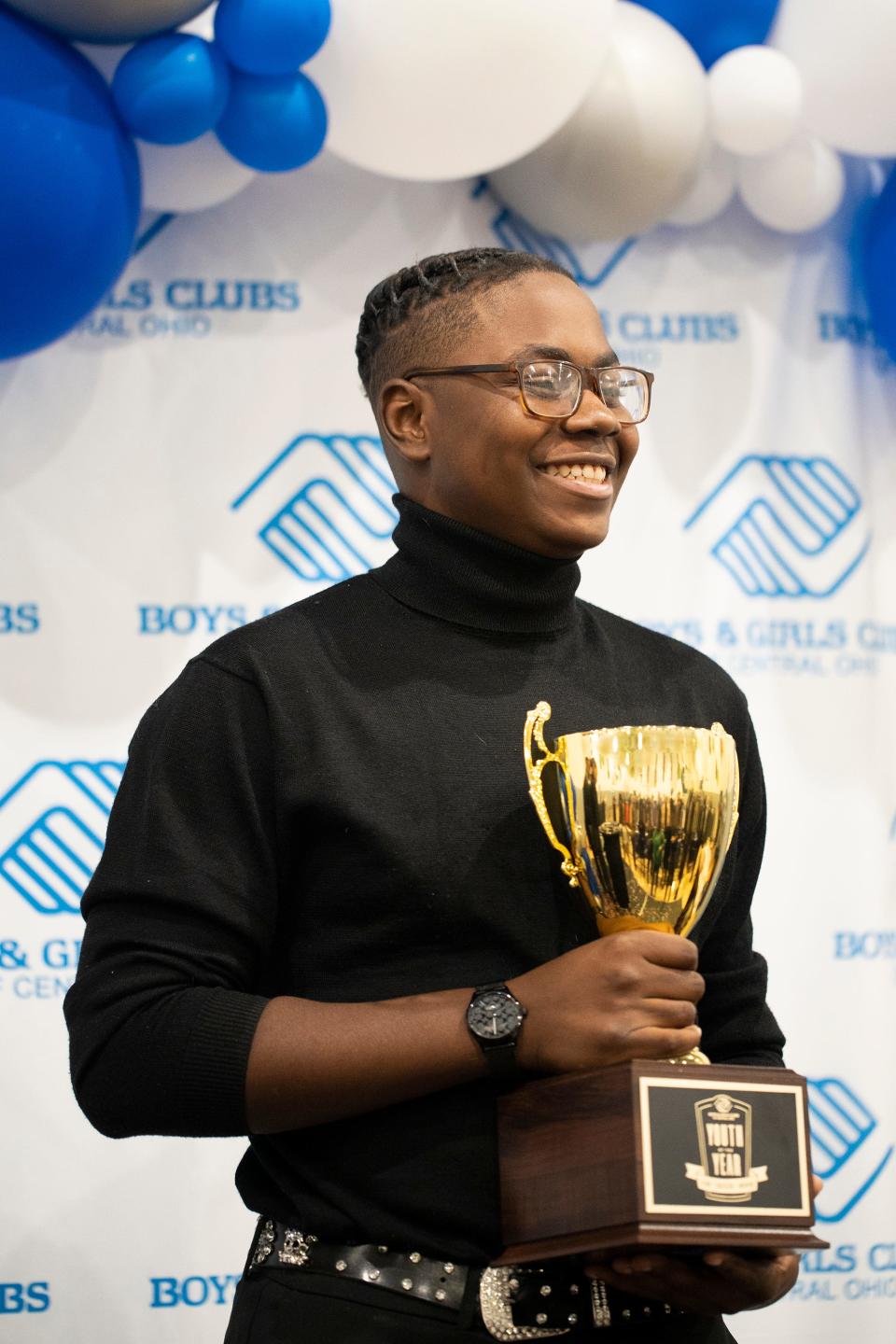 Shonn Tucker poses with his Boys & Girls Clubs of Central Ohio's 2023 Youth of the Year award on Feb. 18, 2023.