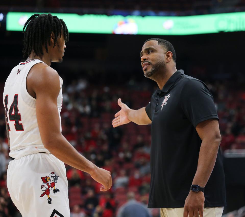 U of L acting head coach Mike Pegues, right, instructed Dre Davis (14) against Southern University during their game at the Yum Center in Louisville, Ky. on Nov. 9, 2021.  U of L won 72-60.