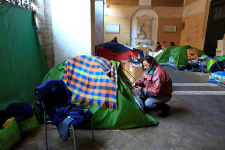 Angela Grossi is seen next to her tent in the portico of the Basilica of the Santi Apostoli, where she lives after being evicted from an unused building along with other families in August 2017, in Rome, Italy January 29, 2018. REUTERS/Tony Gentile