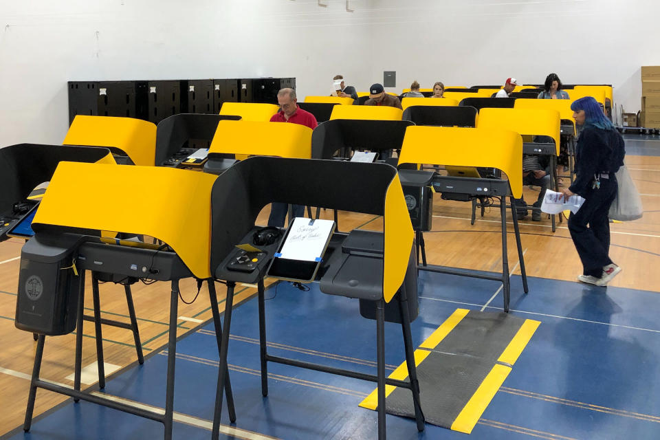 A sign reads "Sorry, Out of Order," on a voting station as people cast the ballots Tuesday, March 3, 2020, at the Silverlake Independent Jewish Community Center in Los Angeles. Poll workers said that computer network issues slowed both the voter check-in process and made some machines unusable. About one-third of the approximately 40 machines were being used. The resulting line meant voting took about an hour. (AP Photo/Justin Pritchard)