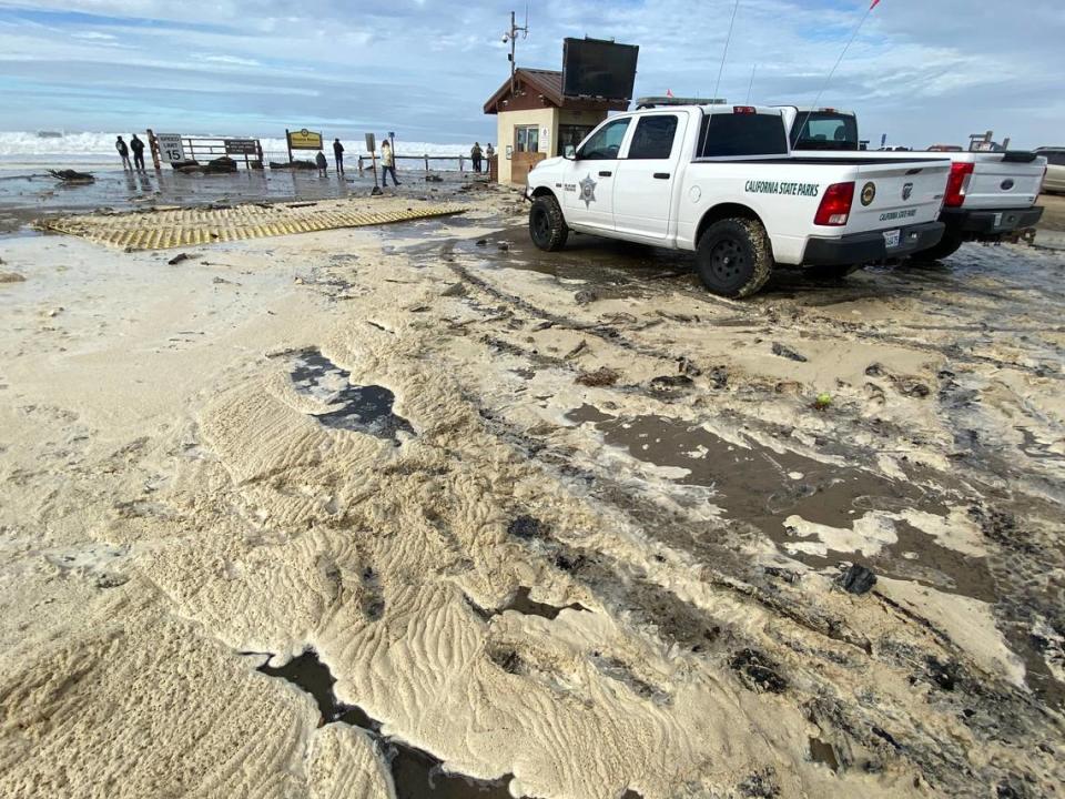 High surf left foam around the Pier Avenue kiosk at the Oceano Dunes State Vehicular Recreation Area on Dec. 28, 2023.