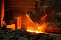 A worker looks at a molten ferroalloy ladle at Eurasian Resources Group's (ERG) Aksu Ferroalloys Plant in the town of Aksu, north-eastern Kazakhstan, February 19, 2018. REUTERS/Shamil Zhumatov/Files