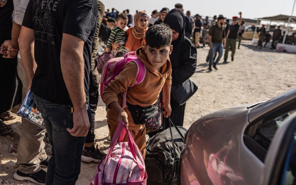 Displaced Syrians from Lebanon arrive in areas controlled by the Syrian opposition in northwestern Syria after crossing at Aoun al-Dadat on Wednesday.