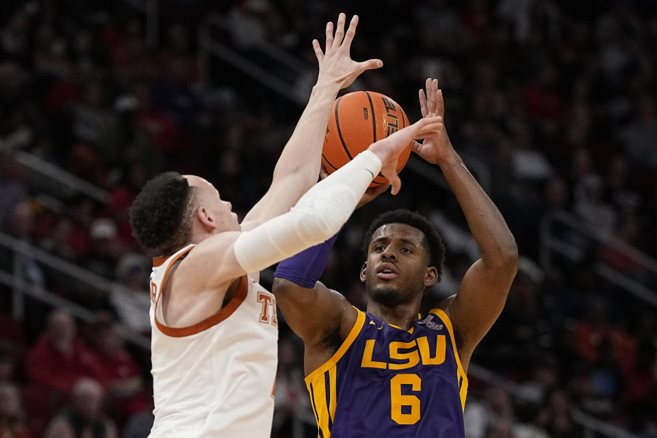 LSU guard Jordan Wright (6) hits a 3-pointer over Texas guard Chendall Weaver during the second half of an NCAA college basketball game, Saturday, Dec. 16, 2023, in Houston. (AP Photo/Kevin M. Cox)