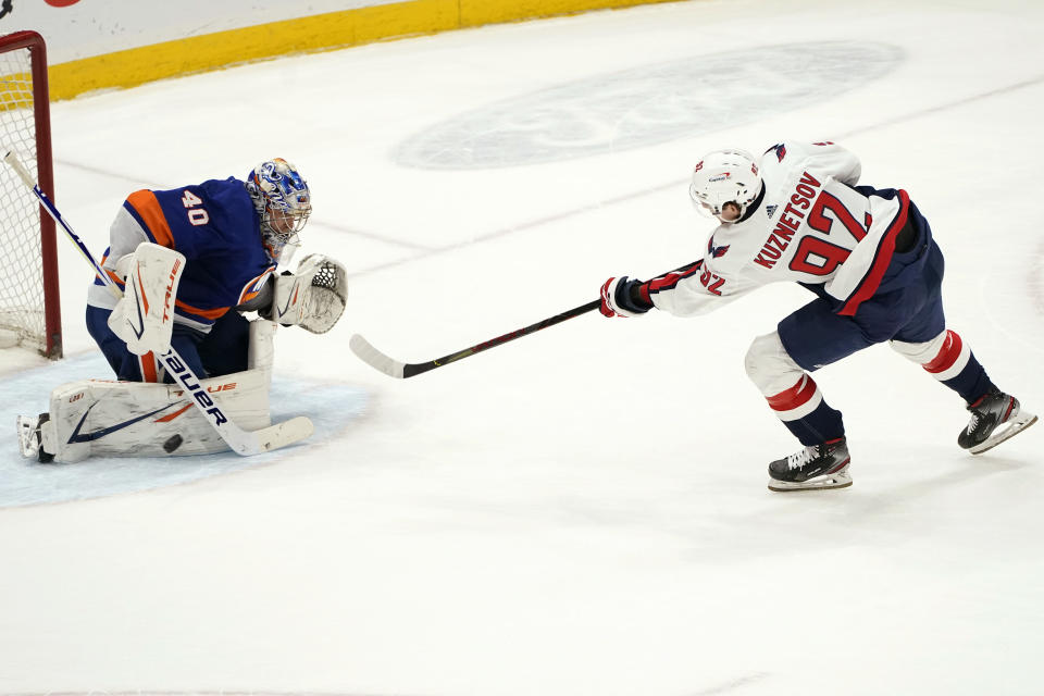 Washington Capitals center Evgeny Kuznetsov (92) scores against New York Islanders goaltender Semyon Varlamov (40) during the shootout in an NHL hockey game, Thursday, April 22, 2021, in Uniondale, N.Y. (AP Photo/Kathy Willens)