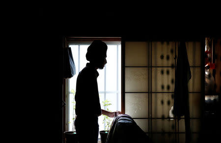 Gursewak Singh is silhouetted against a window in a room of his house while he has an interview with Reuters, in Matsudo, Japan, September 25, 2016. REUTERS/Kim Kyung-Hoon