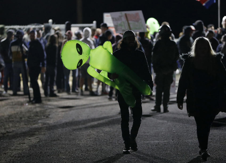 A mans holds an inflatable alien at an entrance to the Nevada Test and Training Range near Area 51 on Sept. 20, 2019, near Rachel, Nev. People gathered at the gate inspired by the "Storm Area 51" internet hoax. (Photo: John Locher/AP)