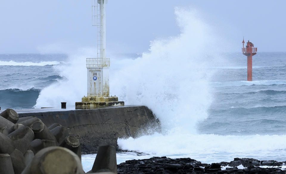 High waves crash a shore as the tropical storm named Khanun approaches to the Korean Peninsular, on Jeju Island, South Korea, Wednesday, Aug. 9, 2023. Dozens of flights and ferry services were grounded in South Korea on Wednesday ahead of the tropical storm that has dumped heavy rain on Japan's southwestern islands for more than a week. (Park Ji-ho/Yonhap via AP)