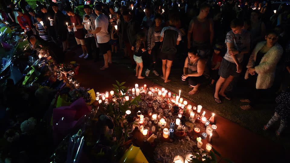 Mourners continue to leave floral tributes and host candle light vigils at the gates of Dreamworld. Photo: AAP