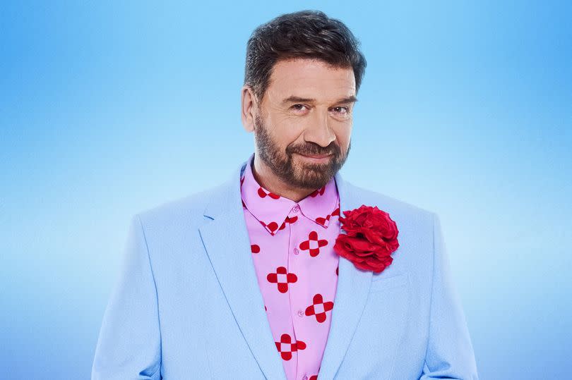 Strictly Come Dancing contestant Nick Knowles in a baby blue suit with a red rose in his lapel