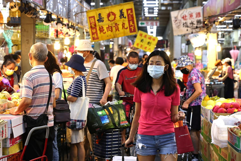 A woman wears a protective face mask while shopping for food at a market, amid a surge in coronavirus disease (COVID-19) infections in Taipei, Taiwan, May 18, 2021. REUTERS/Ann Wang