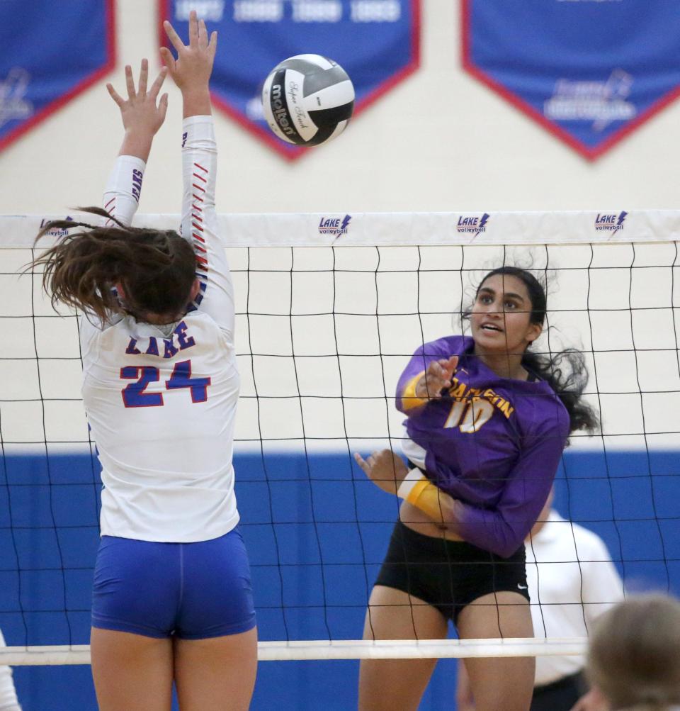 Leena Patibandla, right, of Jackson goes for the kill while being defended by Gwen VanElzen, 24, of Lake during their game at Lake on Thursday, Sept. 1, 2022.