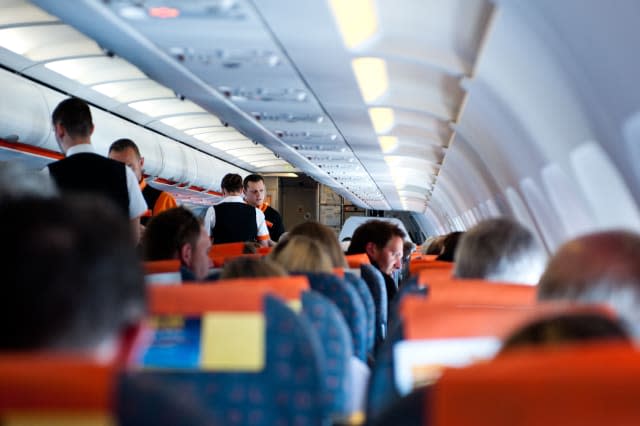 Passengers and flight attendents on a plane