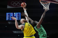 Australia's Aron Baynes (12) and Nigeria's Ekpe Udoh (8) reach for a rebound during a men's basketball preliminary round game at the 2020 Summer Olympics, Sunday, July 25, 2021, in Saitama, Japan. (AP Photo/Eric Gay)