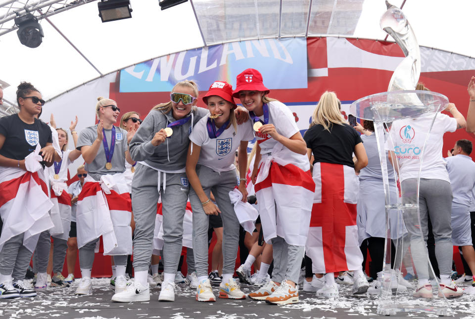 England's Georgia Stanway, Leah Williamson and Ella Toone with their medals on stage during a fan celebration to commemorate England's historic UEFA Women's EURO 2022 triumph in Trafalgar Square, London. Picture date: Monday August 1, 2022.