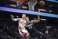 Sacramento Kings forward Keegan Murray (13) is fouled by Houston Rockets guard Garrison Mathews (25) on a shot during the second half of an NBA basketball game in Sacramento, Calif., Wednesday, Jan. 11, 2023. The Kings won 135-115. (AP Photo/José Luis Villegas)