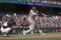 San Diego Padres' Manny Machado hits a two-run single in front of San Francisco Giants catcher Curt Casali during the eighth inning of a baseball game in San Francisco, Thursday, Sept. 16, 2021. (AP Photo/Jeff Chiu)