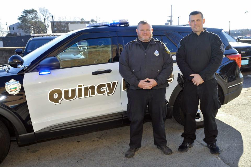 Quincy police officers Michael Brokmeier, left, and Sean Fitzgerald, right, received commendations from the Quincy Police Department for rescuing a man from his burning home.