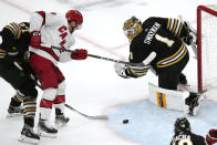 Carolina Hurricanes left wing Teuvo Teravainen, second from left, follows the puck on his goal as Boston Bruins goaltender Jeremy Swayman (1) looks back during the second period of an NHL hockey game, Tuesday, April 9, 2024, in Boston. (AP Photo/Charles Krupa)