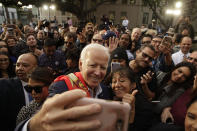 Democratic presidential candidate former Vice President Joe Biden takes selfies with supporters at a campaign rally at Los Angeles Trade Technical College in Los Angeles Thursday, Nov. 14, 2019. (AP Photo/Damian Dovarganes)