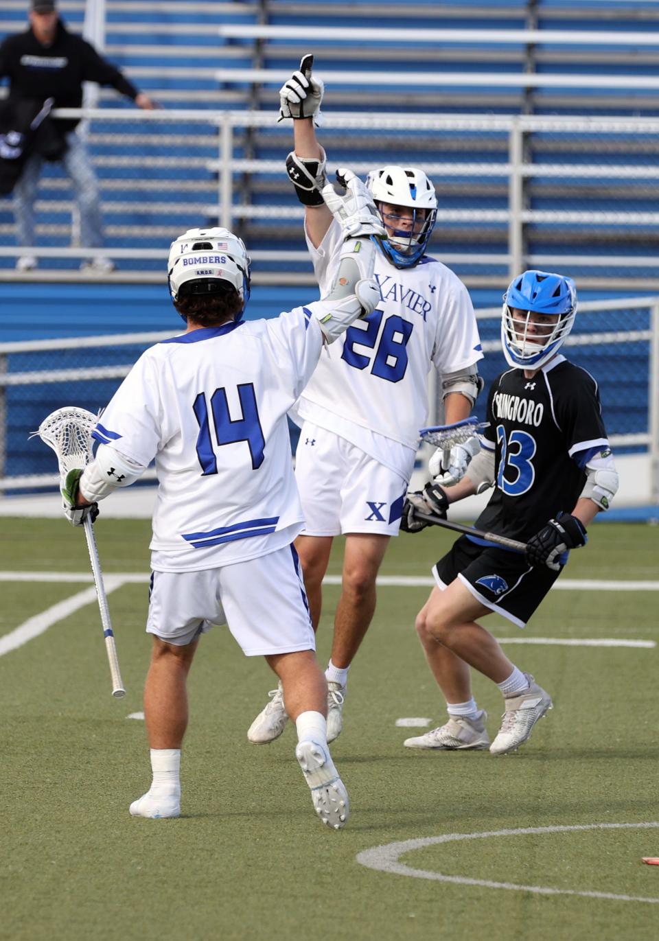 Saint Xavier players Harry Albach (28) and Luke Vrsansky celebrate Albach's goal against Springboro in the Division I regional championship game at Saint Xavier May 27, 2022.