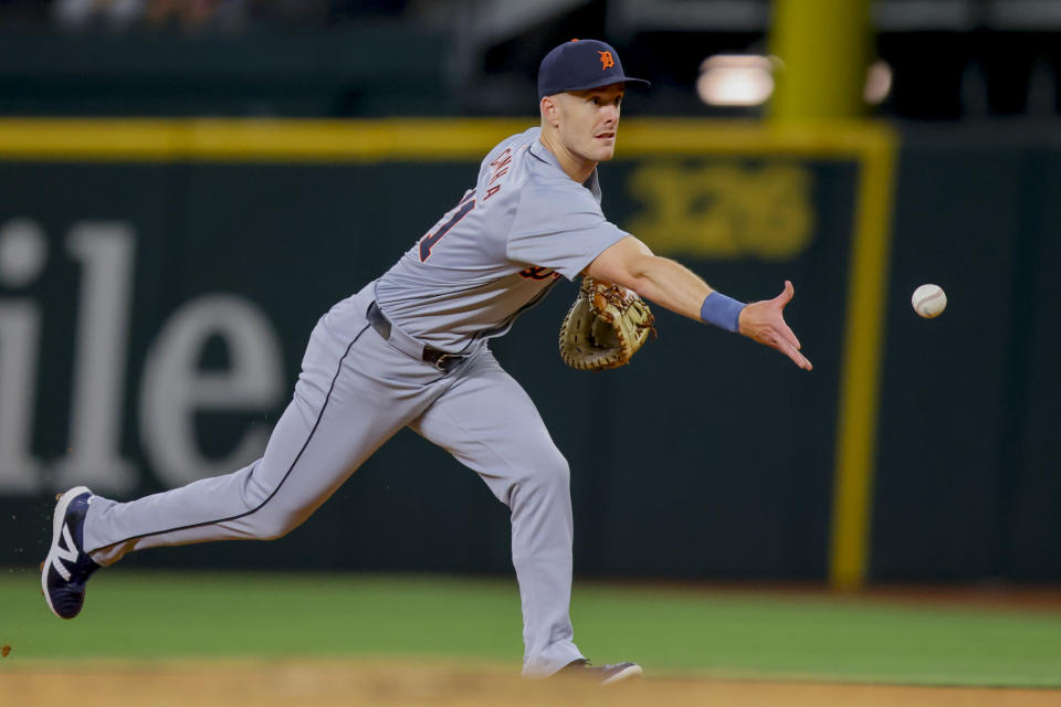 Detroit Tigers first baseman Mark Canha tosses the ball to starting pitcher Tarik Skubal after fielding a grounder from Texas Rangers' Robbie Grossman during the first inning of a baseball game Monday, June 3, 2024, in Arlington, Texas. (AP Photo/Gareth Patterson)