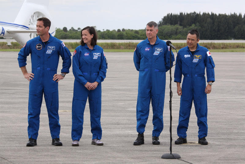 The SpaceX Crew-2 astronauts greet senior managers and reporters at the Kennedy Space Center runway after flying in from Houston to prepare for launch Thursday to the International Space Station. Left to right: European Space Agency astronaut Thomas Pesquet, NASA astronaut Megan McArthur, mission commander Shane Kimbrough and Japanese astronaut Akihiko Hoshide. / Credit: Stephen Clark/Spaceflight Now