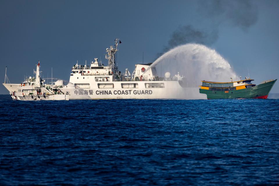 A Chinese Coast Guard ship fires a water cannon at Unaizah May 4, a Philippine Navy-chartered ship, conducting a routine resupply mission for troops deployed at Second Thomas Shoal in the South China Sea, March 5, 2024.