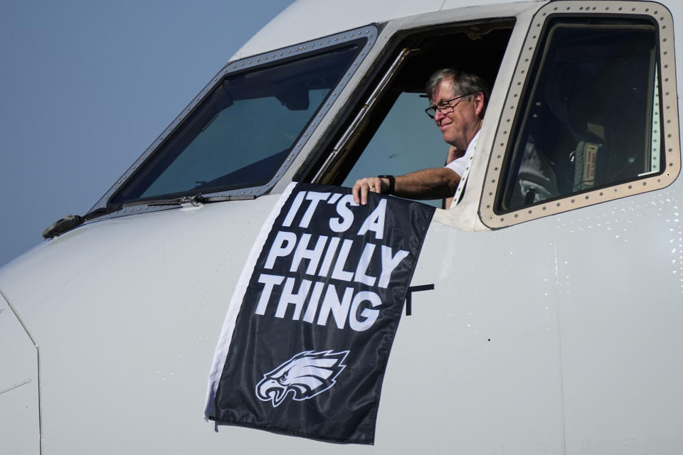 A Philadelphia Eagles flag is held as the team arrives ahead of Super Bowl 57, Sunday, Feb. 5, 2023, in Phoenix. The Kansas City Chiefs will play the Philadelphia Eagles on Sunday.(AP Photo/Matt York)