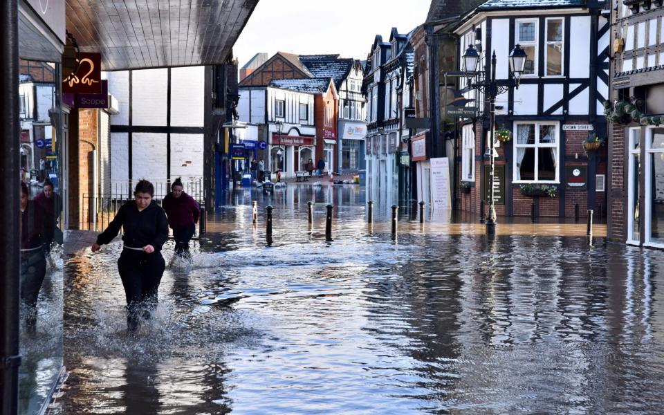 Shopkeepers fight to save their shops from rising floodwater in Witton Street, Northwich - Nick Jones / SWNS 