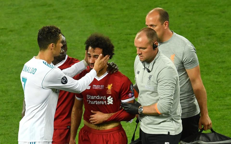 Cristiano Ronaldo comfort Mohamed Salah as he leaves the pitch in tears  - 2018 Getty Images