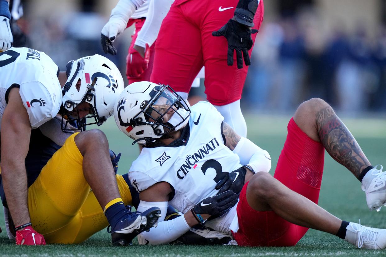 Cincinnati Bearcats safety Deshawn Pace (3) grimaces after suffering an injury in the first quarter during an NCAA college football game between the Cincinnati Bearcats and the West Virginia Mountaineers, Saturday, Nov. 18, 2023, at Milan Puskar Stadium in Morgantown, W. Va.