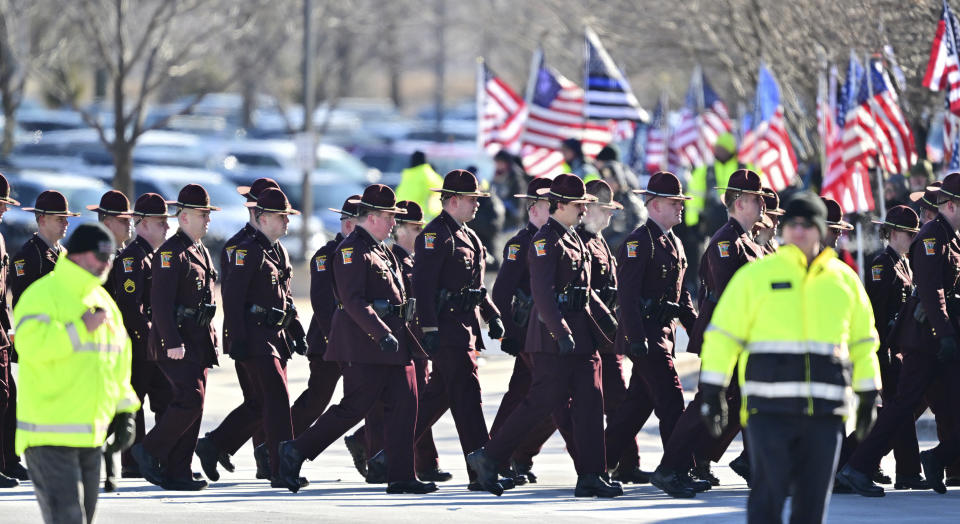 Minnesota State Troopers march into a a memorial service for three slain Burnsville first responders at Grace Church in Eden Prairie, Minn. on Wednesday, Feb. 28, 2024. Burnsville police officers Paul Elmstrand and Matthew Ruge, along with firefighter-paramedic Adam Finseth, were killed in the line of duty Feb. 18. (John Autey/Pioneer Press via AP)