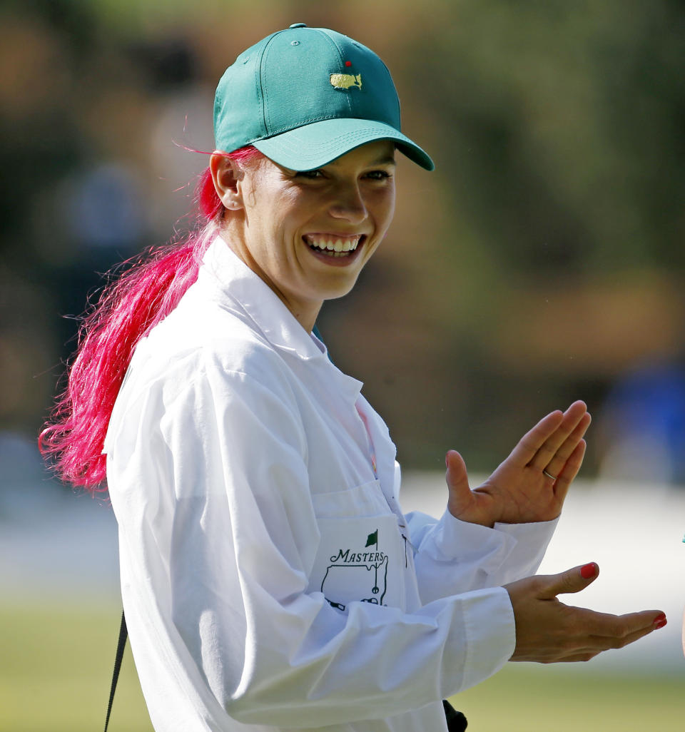 Tennis player Caroline Wozniacki applauds her fiancee Rory McIlroy, of Northern Ireland, during the par three competition at the Masters golf tournament Wednesday, April 9, 2014, in Augusta, Ga. (AP Photo/Matt Slocum)