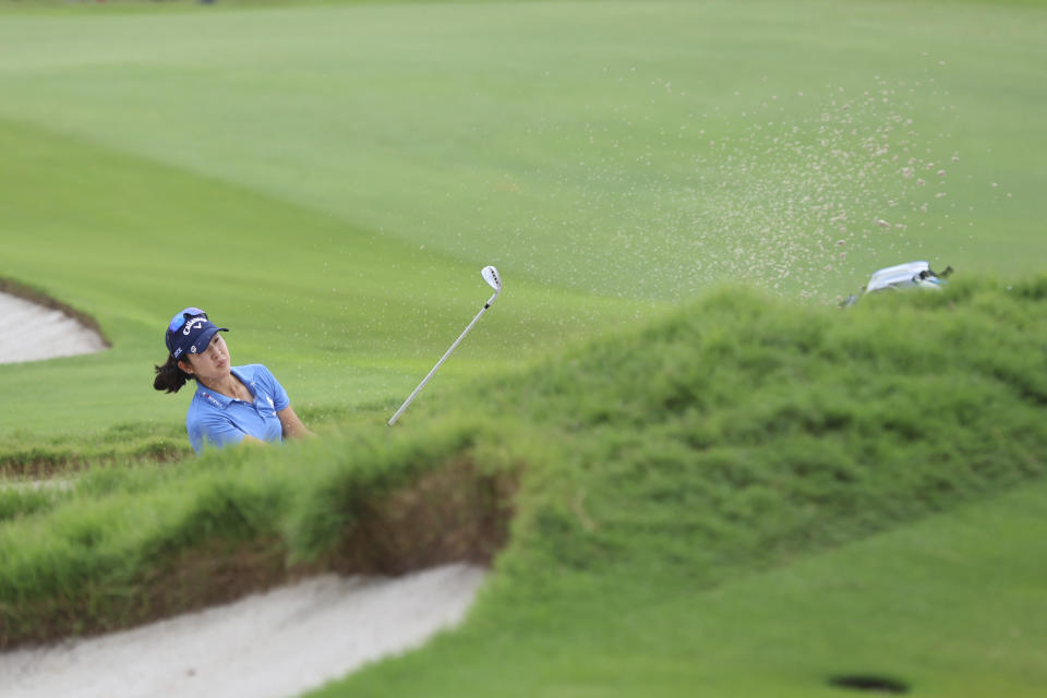 Andrea Lee of the U.S. plays a shot from the bunker of the 18th hole during the final round of the HSBC Women's Wold Championship at the Sentosa Golf Club in Singapore Sunday, March 3, 2024. (AP Photo/Danial Hakim)