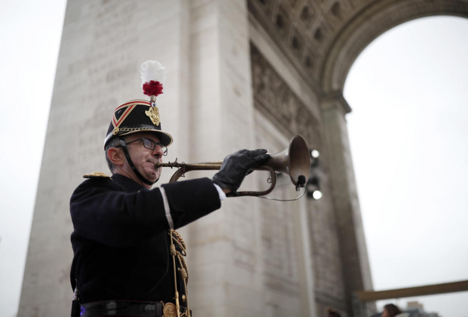 A Republican Guard blows a bugle that signaled the Armistice in 1918 before a commemoration ceremony for Armistice Day, 100 years after the end of the First World War at the Arc de Triomphe in Paris, Sunday, Nov. 11, 2018. (Benoit Tessier/Pool Photo via AP)